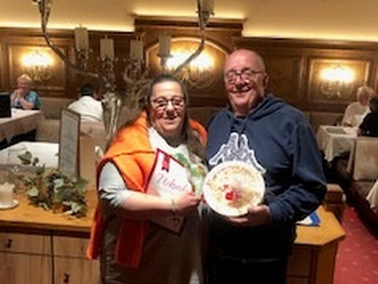 Paar posiert mit Urkunde anlässlich Gästeehrung