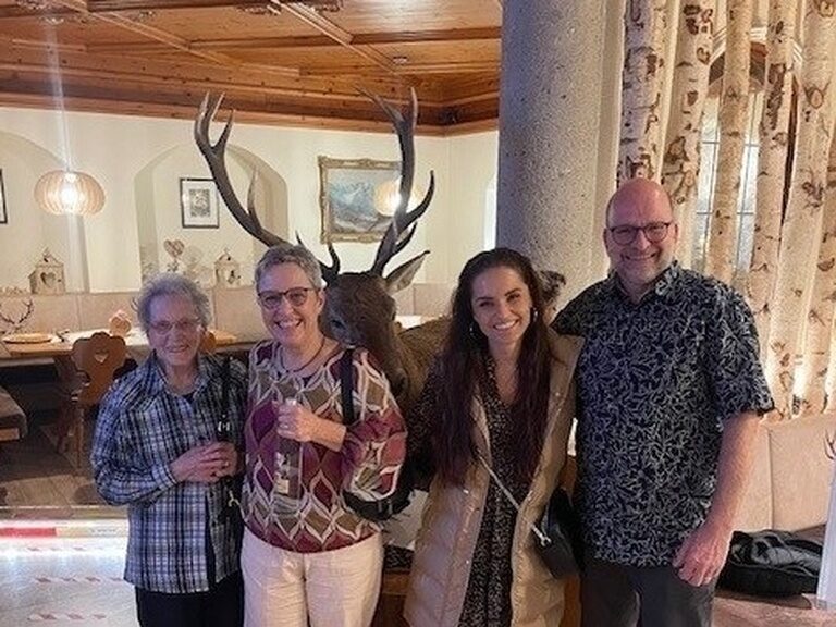 vier Gäste lächeln und posieren anlässlich Geburtstag